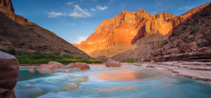 The tourquoise waters of the Little Colorado River near its confluence with Colorado River in the Grand Canyon with dawn light on Chuar Butte, AZ.